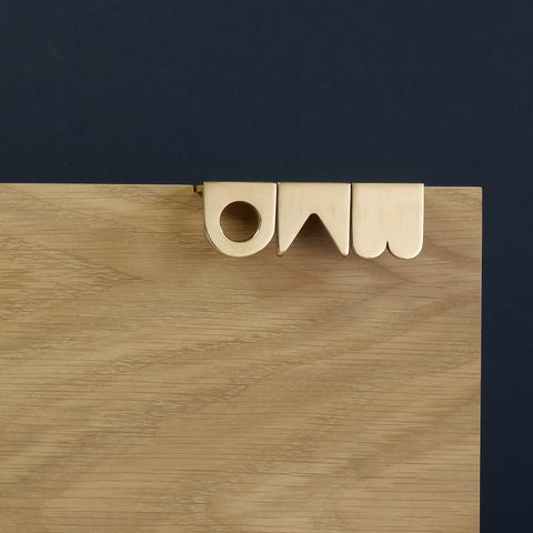 Symbols handle collection in polished brass